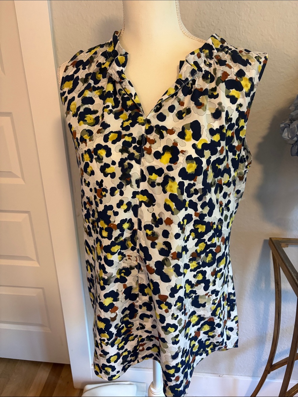 Cabi Sleeveless Printed V-Neck blouse in White Navy brown and yellow.
